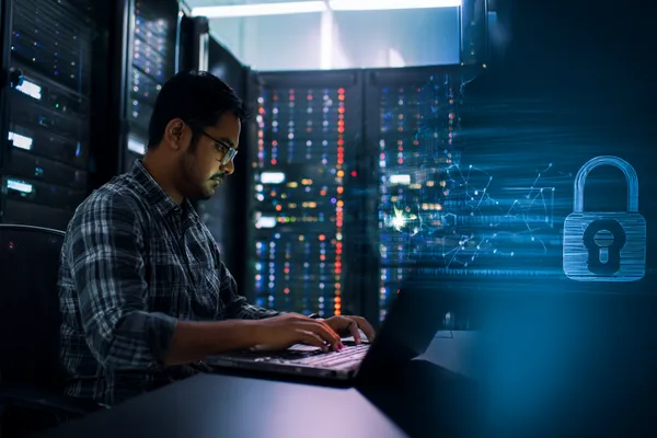 A woman smiling while playing online games on her laptop, surrounded by neon casino elements, showcasing ZS777’s diverse game collection.