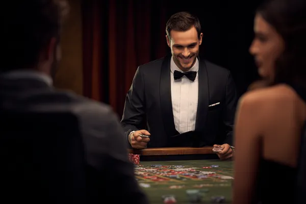 ZS777 — A high-class gaming experience without limits A woman in a luxurious green gown next to an ornate roulette wheel, capturing the upscale casino mood of ZS777.
